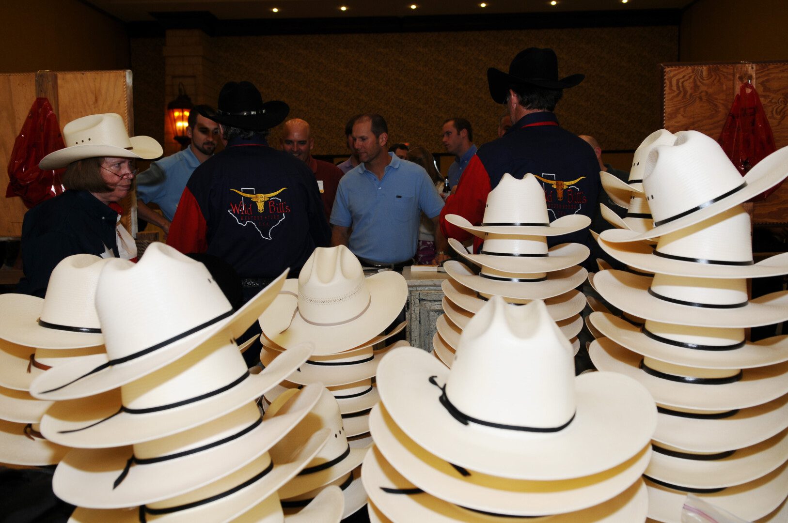 A group of men standing around each other wearing hats.