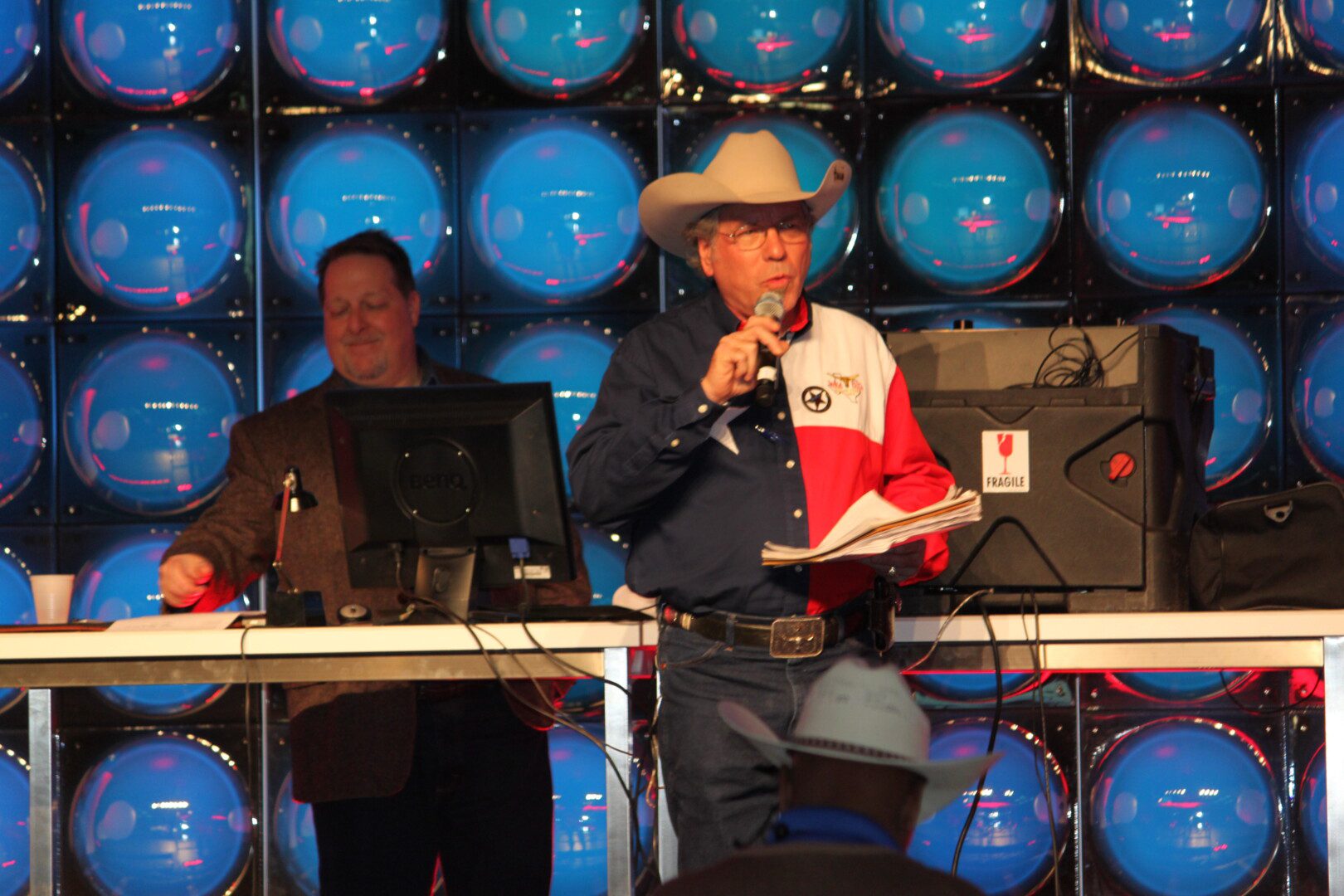 A man in cowboy hat speaking at an event.