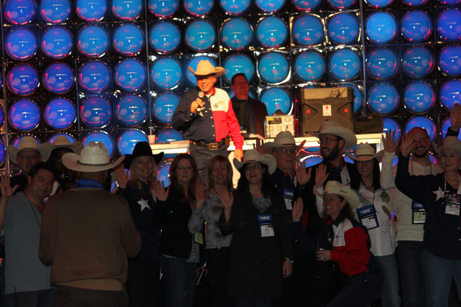 A group of people in cowboy hats and blue balls.