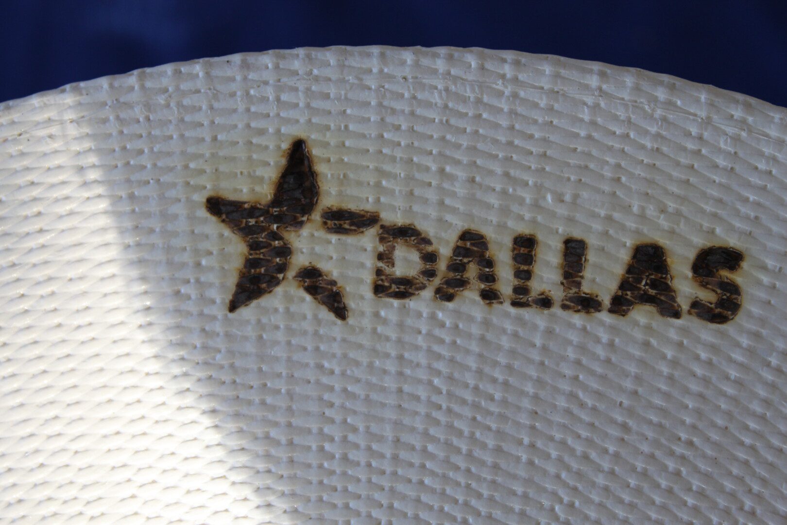 A close up of the word dallas written on top of a hat.