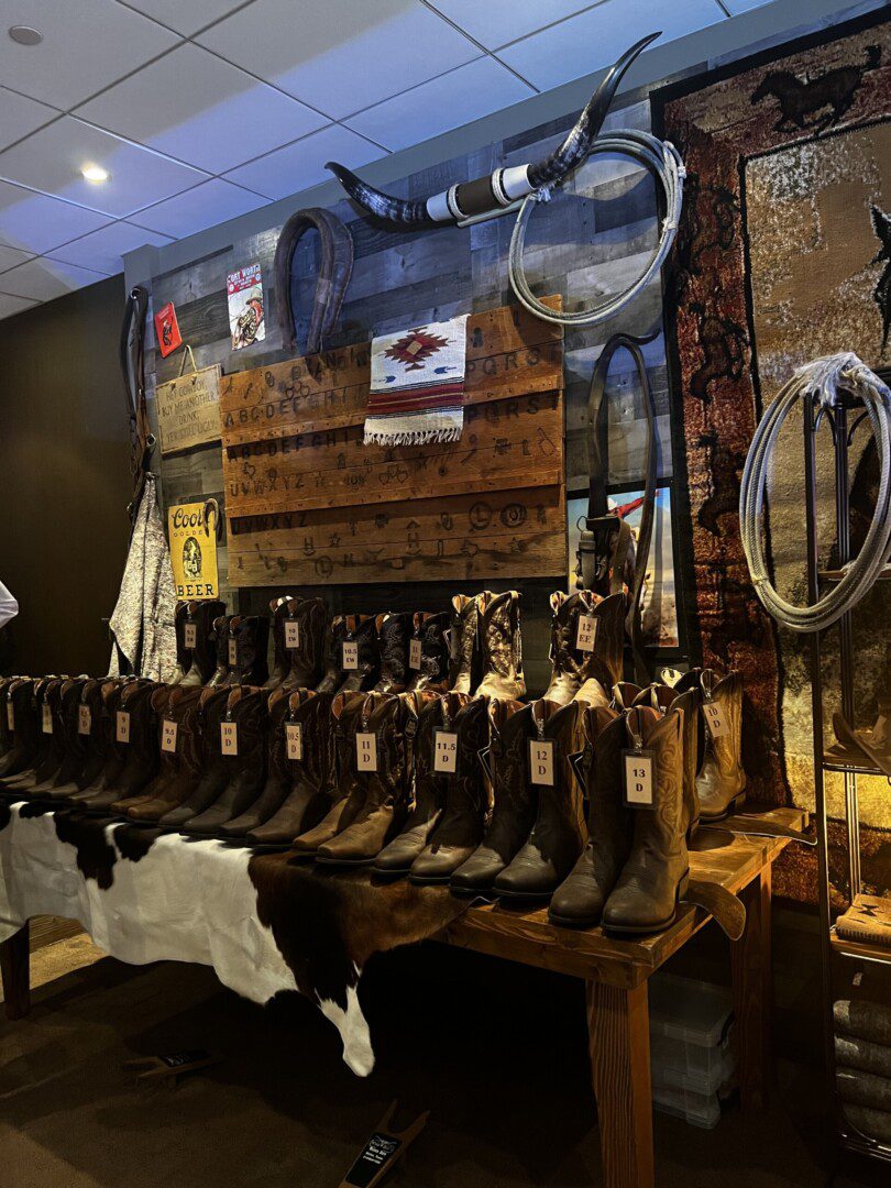 A display of cowboy boots and other western items.