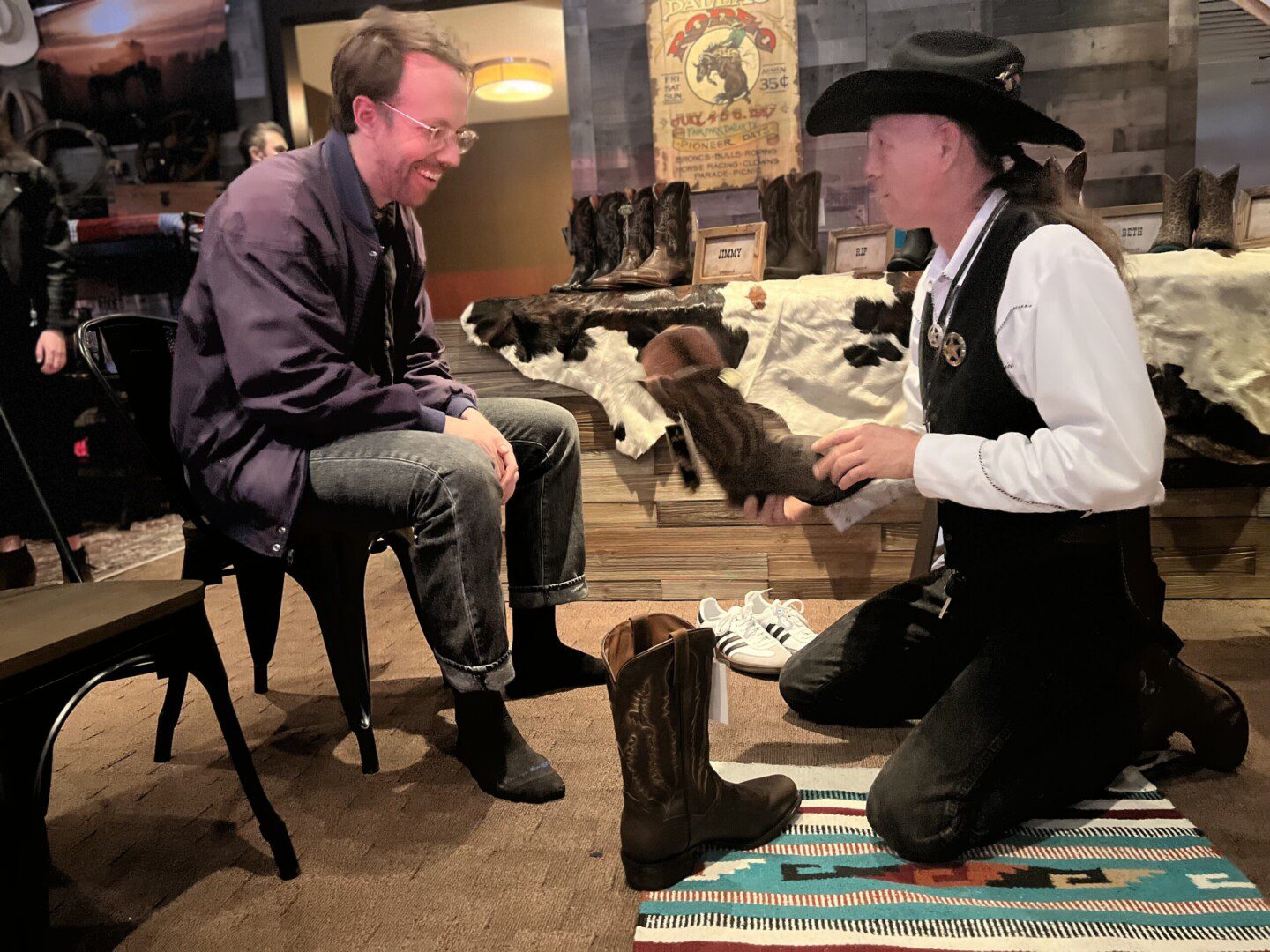 Two men sitting on chairs in a room.