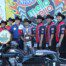 A group of men standing next to motorcycles.