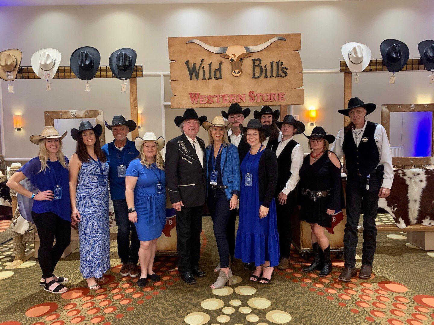 A group of people in cowboy hats and blue dresses.